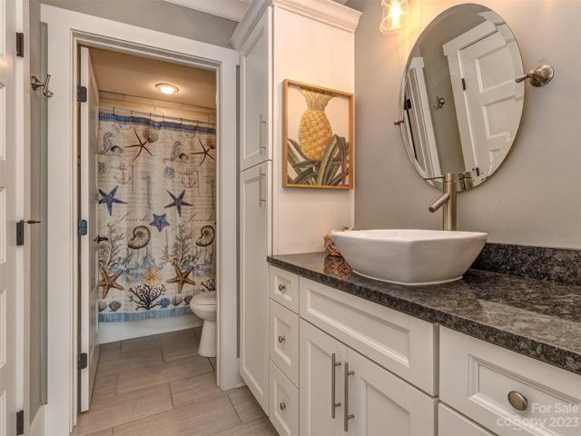 Guest Bath with Granite Countertop, Custom Sink, Tile Flooring & Tub/Shower