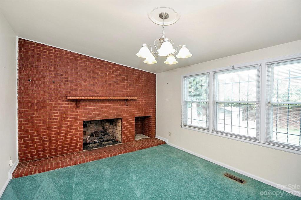 Den is loaded with light and features a fireplace