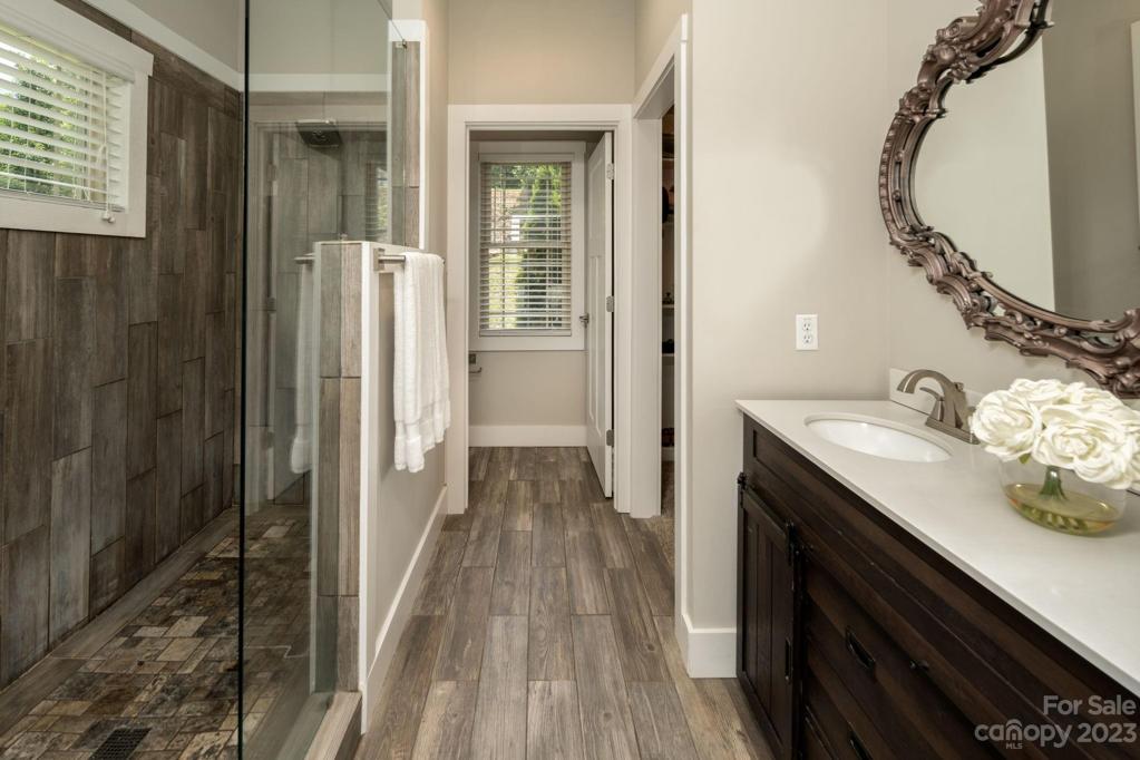 The adjacent granite bathroom offers dual sinks, radiant floor heating and a luxury walk-in tile shower.