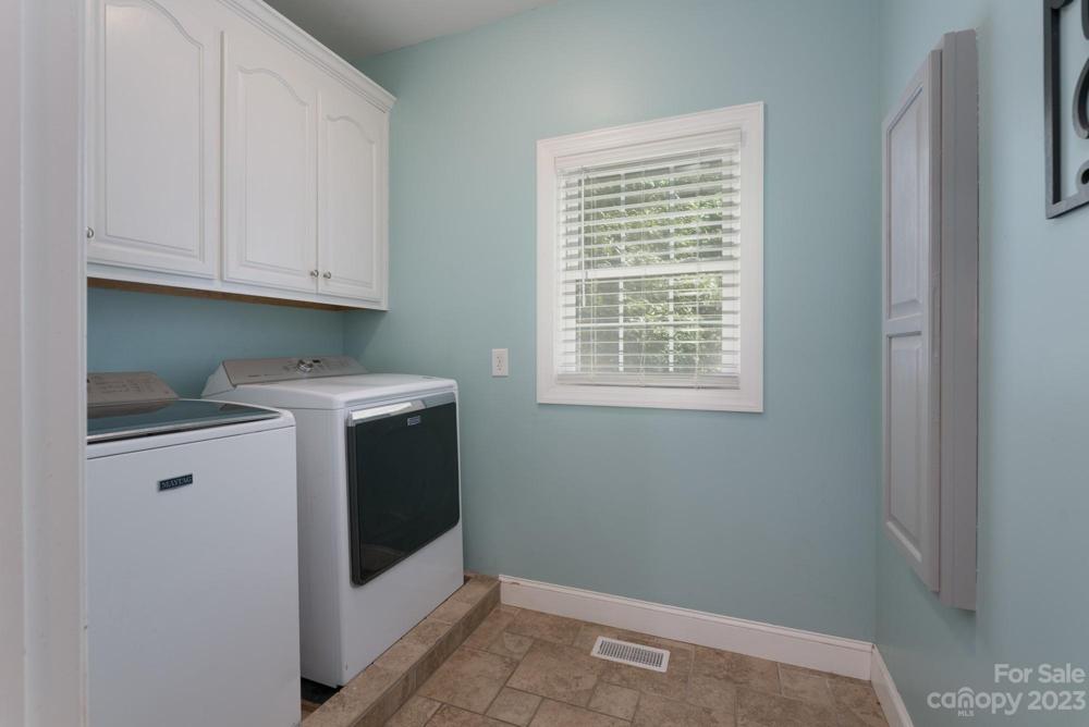Great laundry room with storage and drop down ironing board