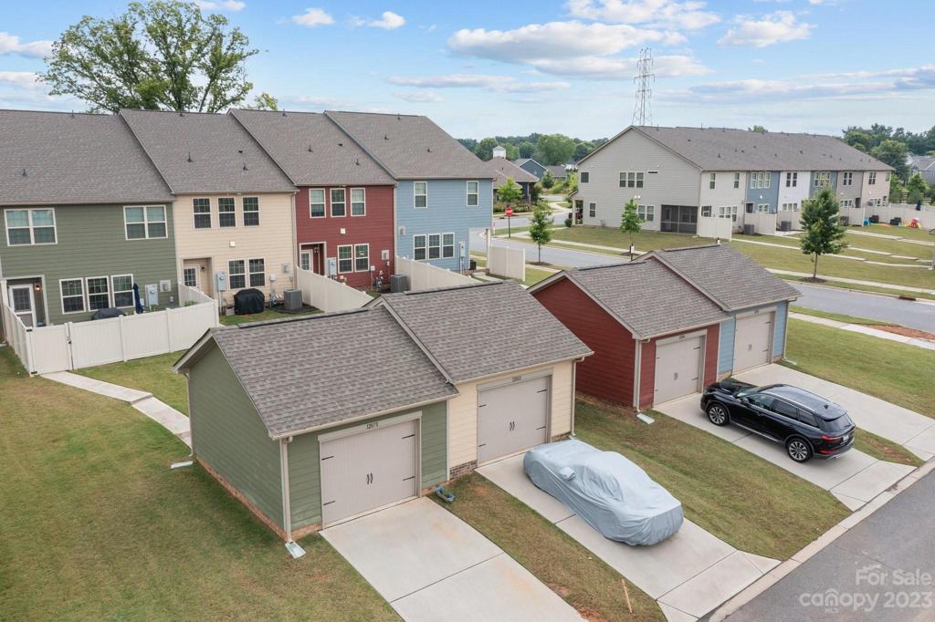Stylish detached garages and ample additional parking here and at the front entry of townhomes.
