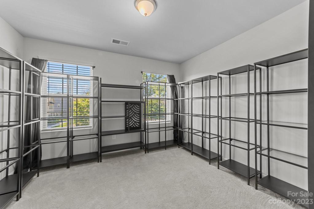 Upstairs Front bedroom #1 was used for modeling! Shelves not attached or included.  It's ample sized and has plenty of natural light!