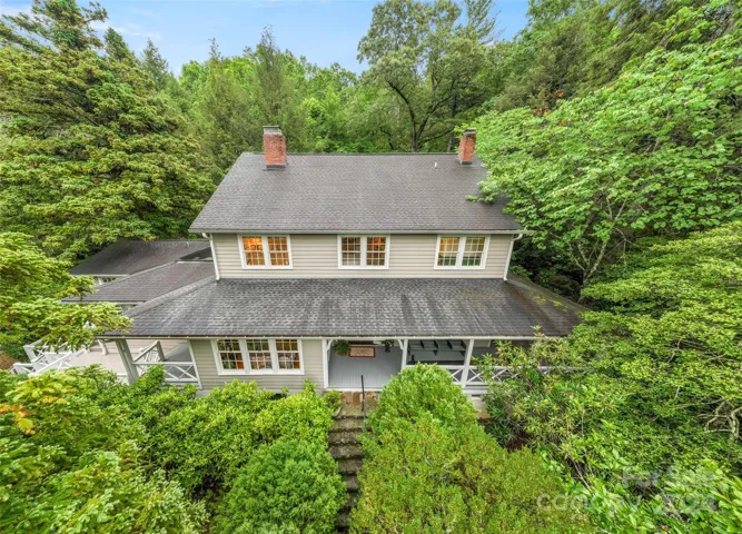 Captivating  home on 1.15 acres surrounded by canopy of treasurered trees