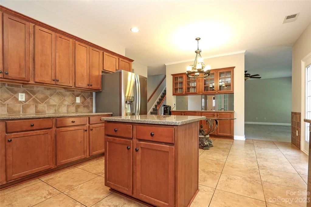 Gourmet Kitchen, granite countertops, w/Island, Custom Backsplash,SS Appliances, Butlers Pantry.