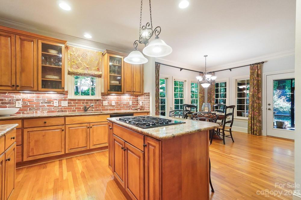 Designer wooden cabinets with brick backsplash