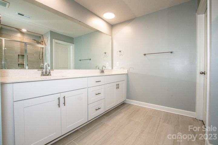 wonderful primary bath with double sinks, large shower. tiled floor
