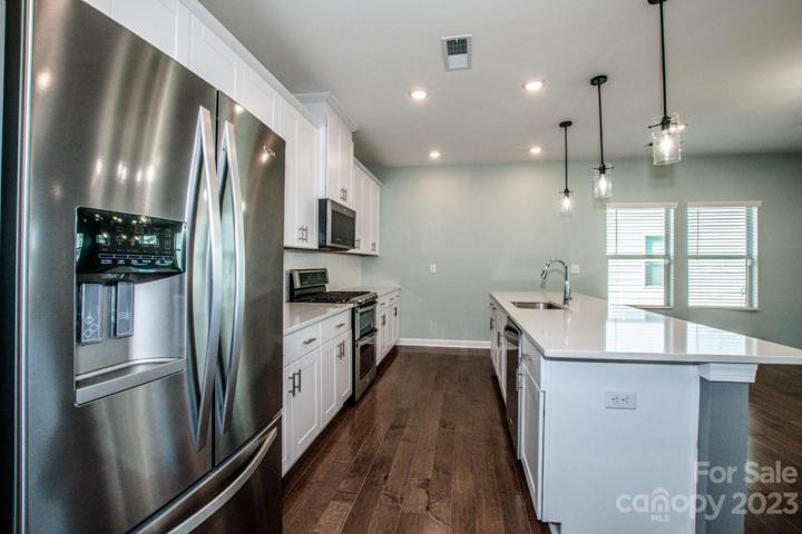 Large center island, stainless appliances, hardwood floors