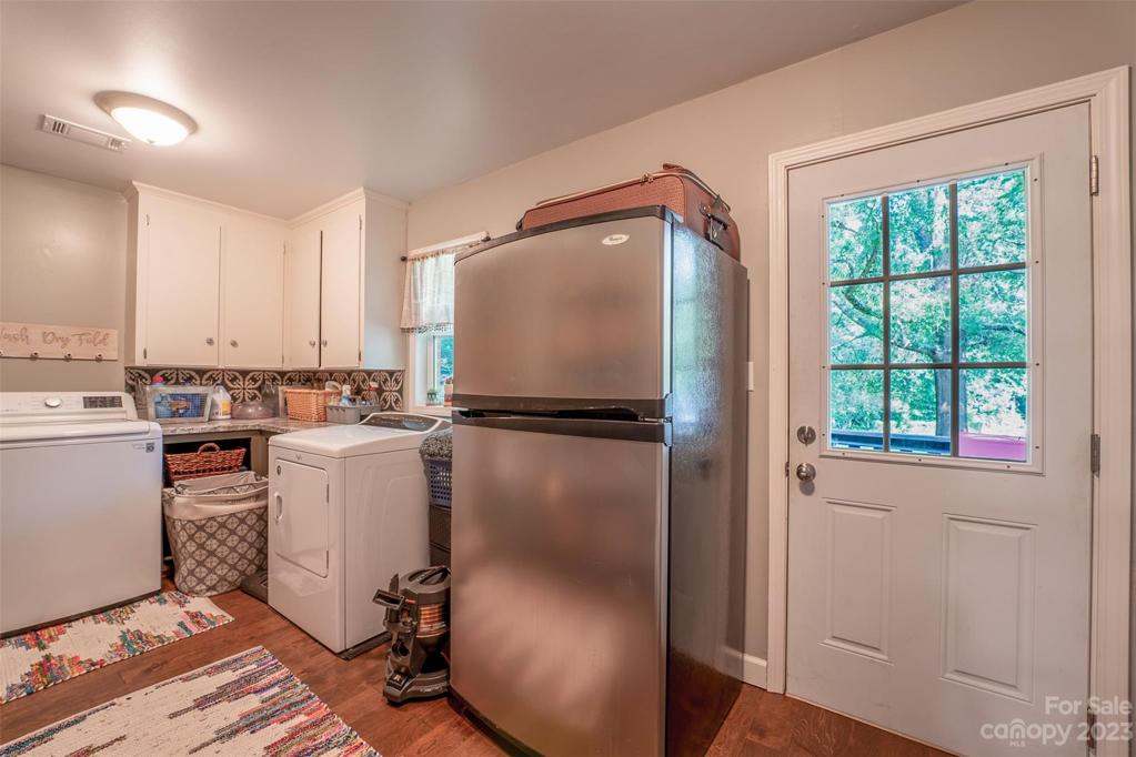 Oversized laundry room - countertop area w/ cabinets make for a super convenient chore day!