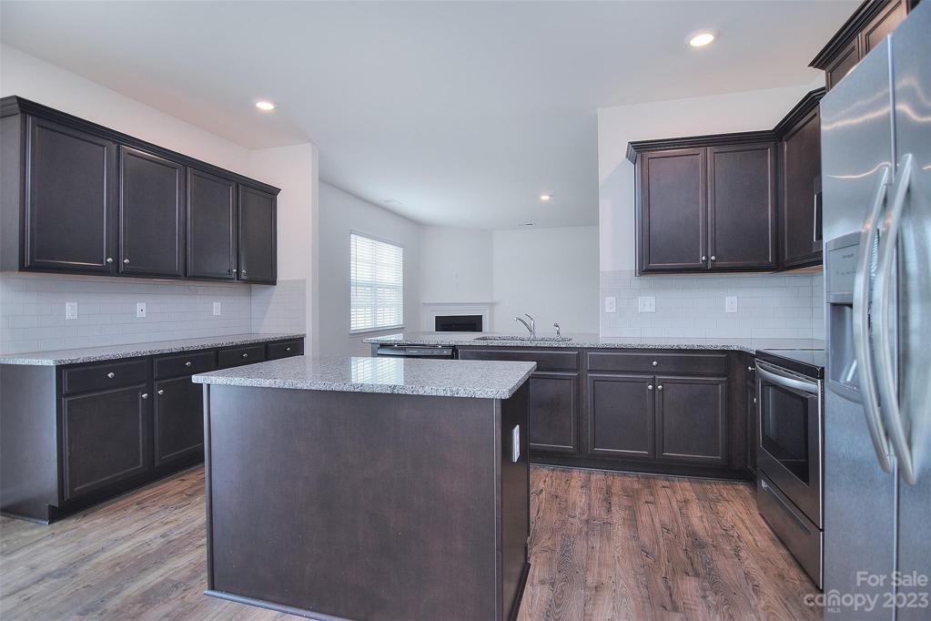 Countertops and island offer plenty of food prep or storage space for smaller kitchen appliances
