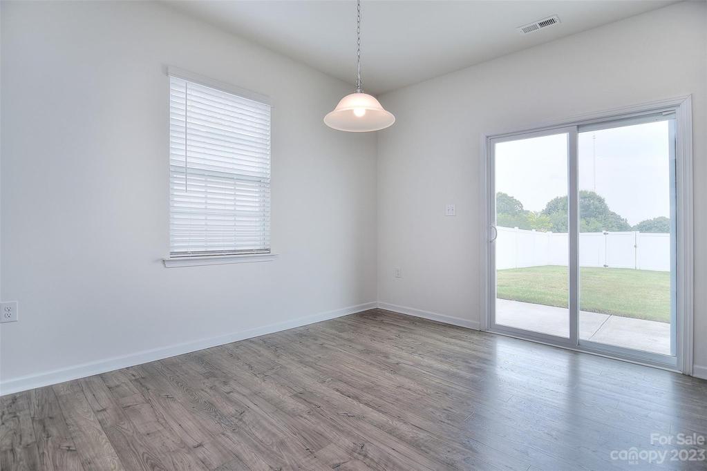 Breakfast nook also receives natural light from window and sliding glass doors