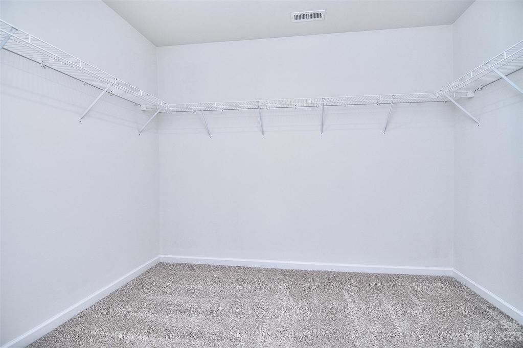 Primary bedroom walk in closet