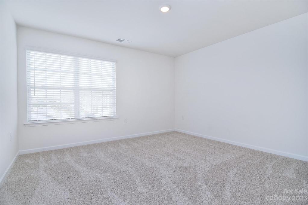 Third bedroom - large windows and carpet can be found throughout the second floor