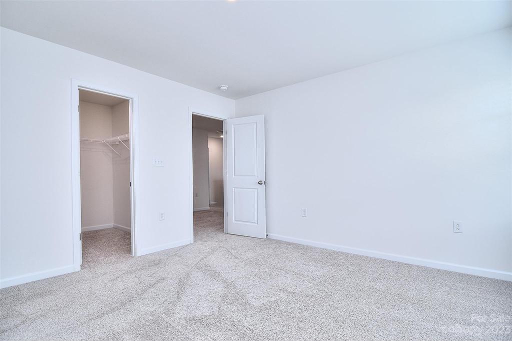 View of walk in closet in third bedroom