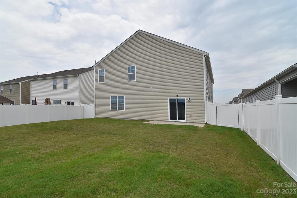 The backyard is a blank canvas for landscaping or outdoor furniture