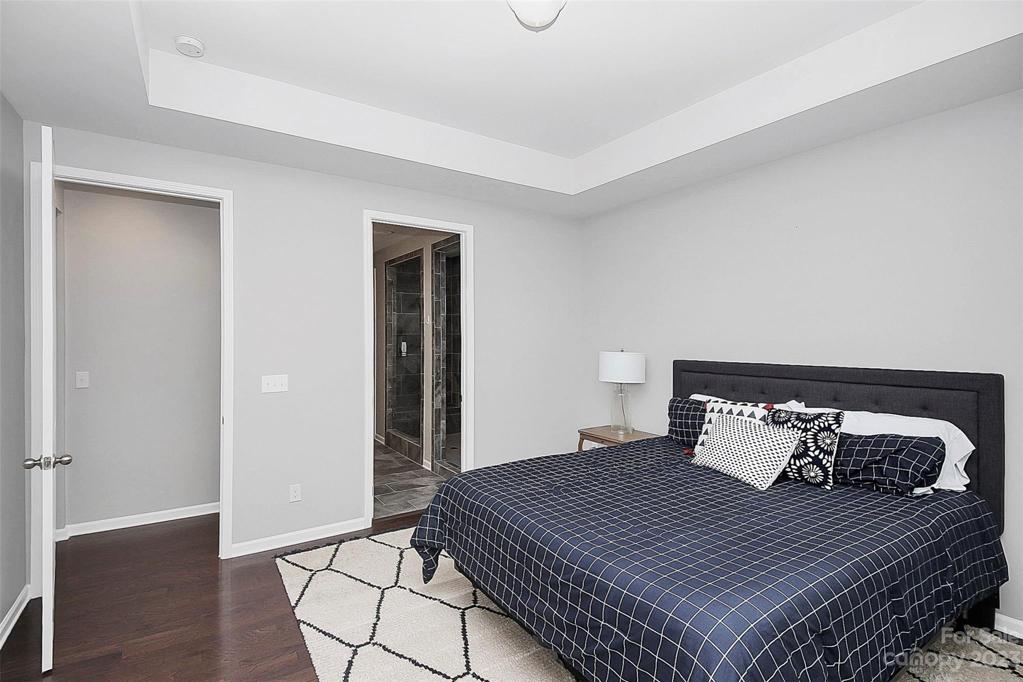 Features tray ceiling and wood flooring