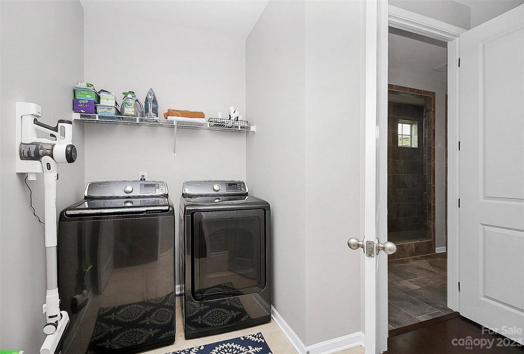 Laundry room off the hallway + connects to primary suite (washer/dryer to convey)