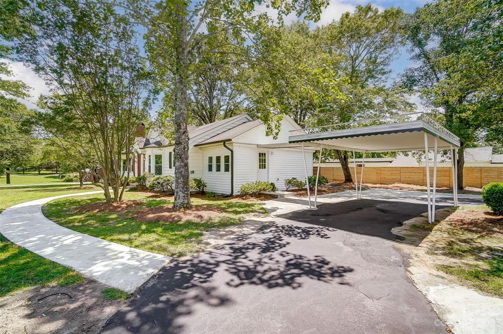 Carport with covered walkway offers protection from the elements.