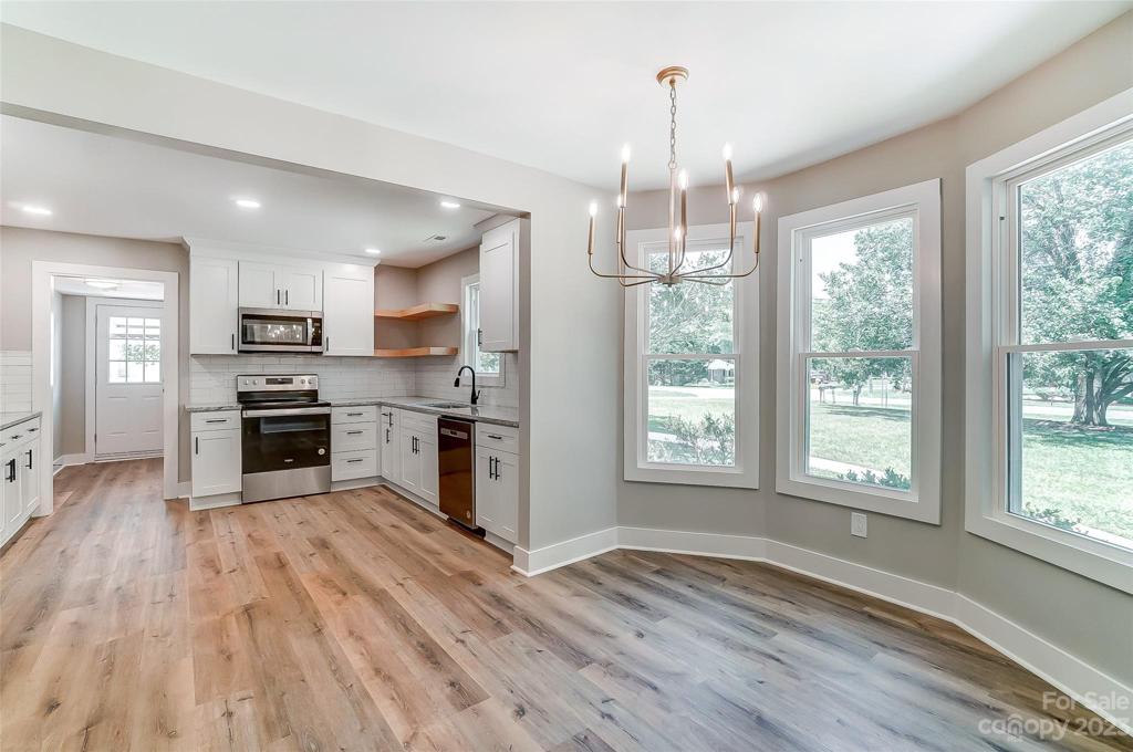 Decedant dining area with bay window and open to the kitchen for convenience.
