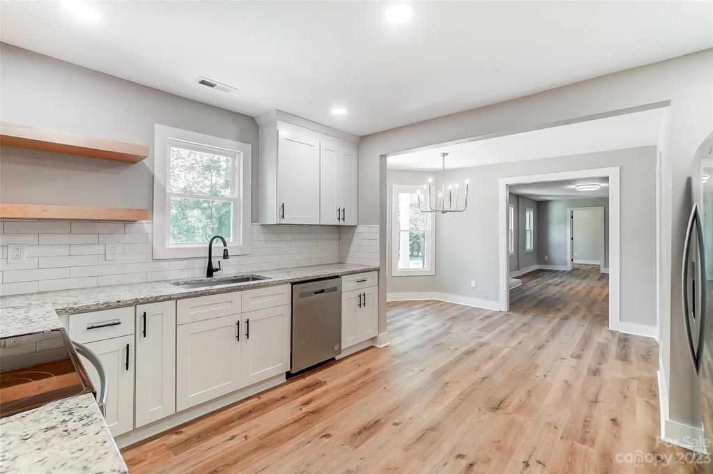 Custom subway tile backsplash and designer cabinet pulls accentuate this kitchen's beauty.
