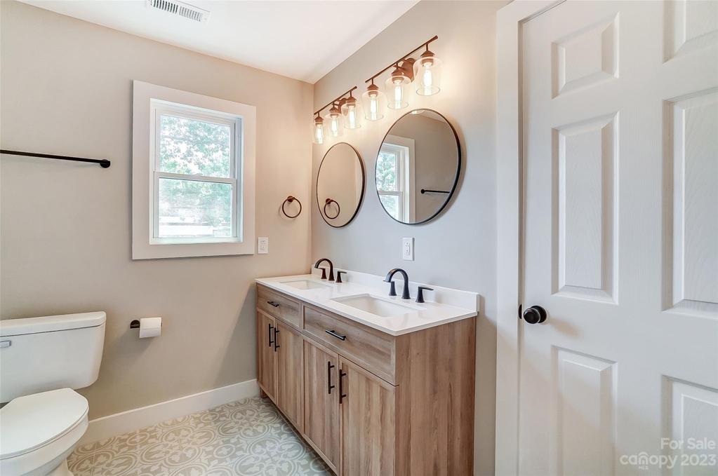 Shared hall bathroom with designer tile and elegant modern touches.