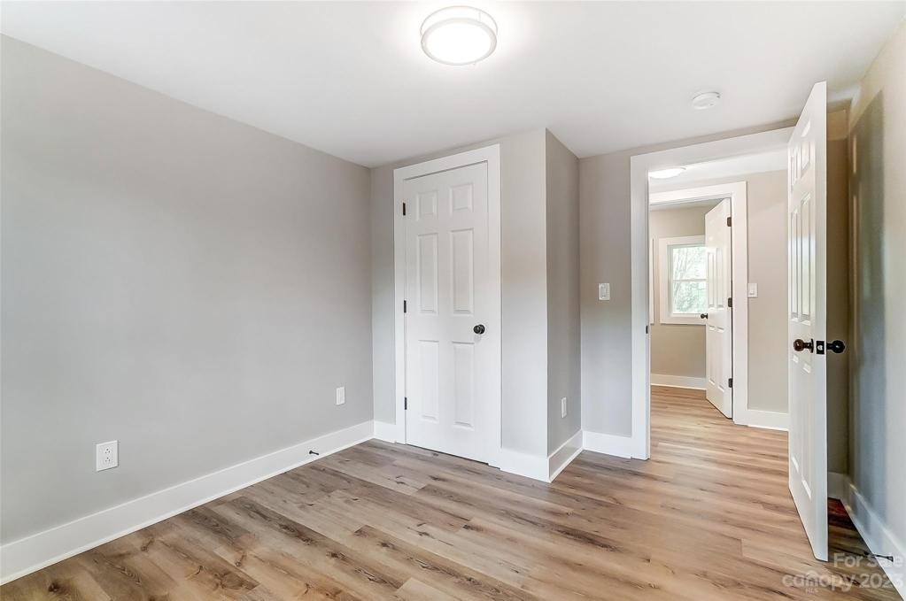 Fourth Bedroom is conveniently located across from the laundry room and near the side entrance.