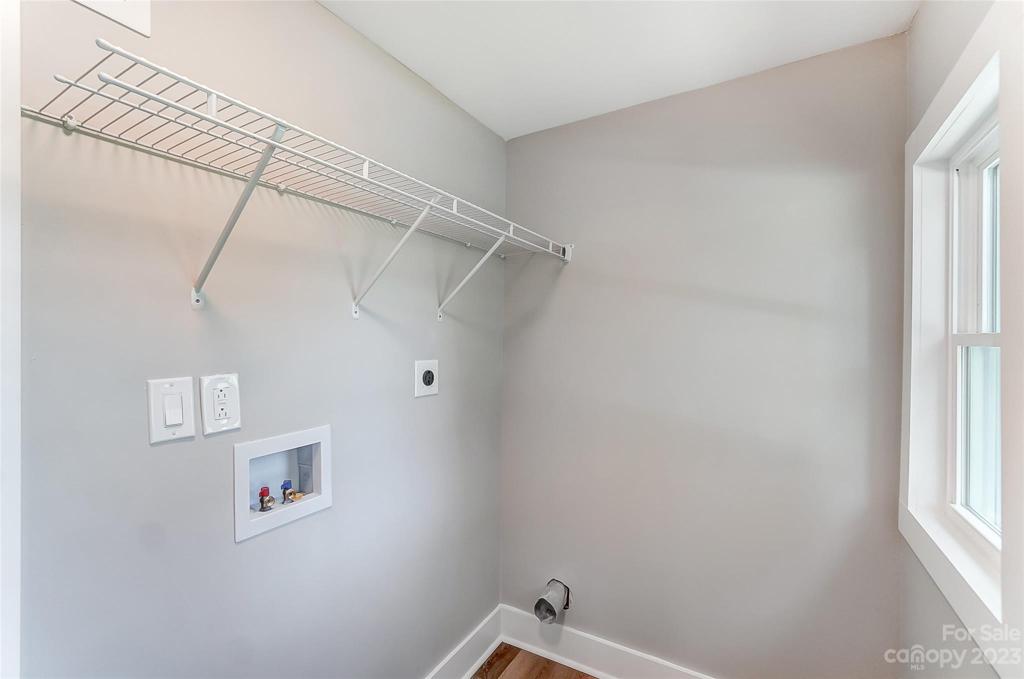 Dedicated laundry room with ventilated shelving.