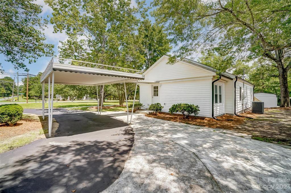 Carport and extended circular drive welcome you home.