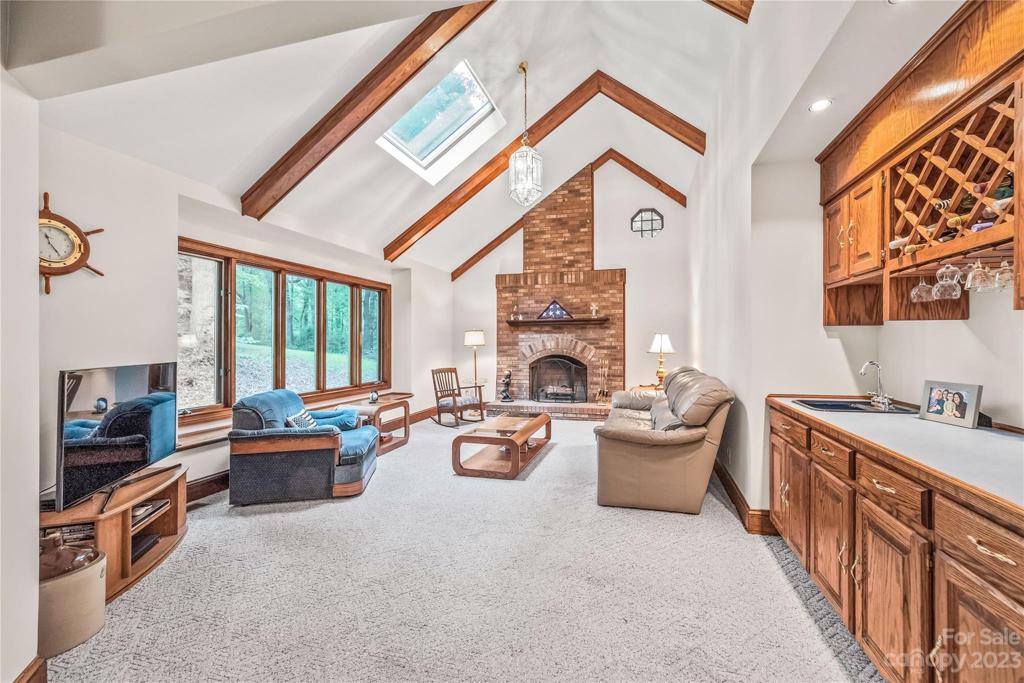 Family room with wet bar off of kitchen and wood burning fireplace