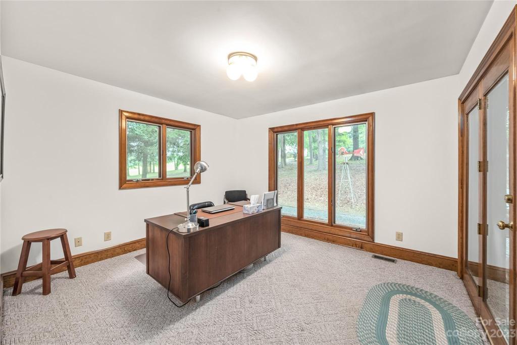 office space with door leading to covered back deck, very bright room