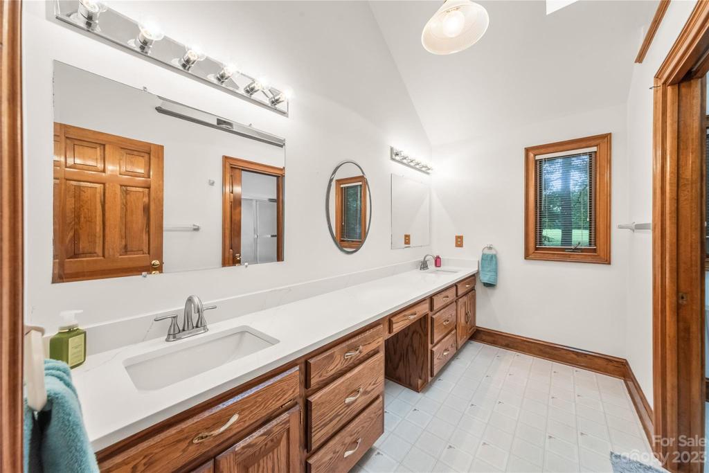 Upstairs hall Full Bath with updates and pocket door separating double vanity from toilet and shower/tub combo!