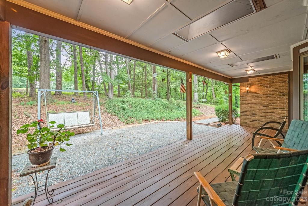 view of trees and backyard from rear porch