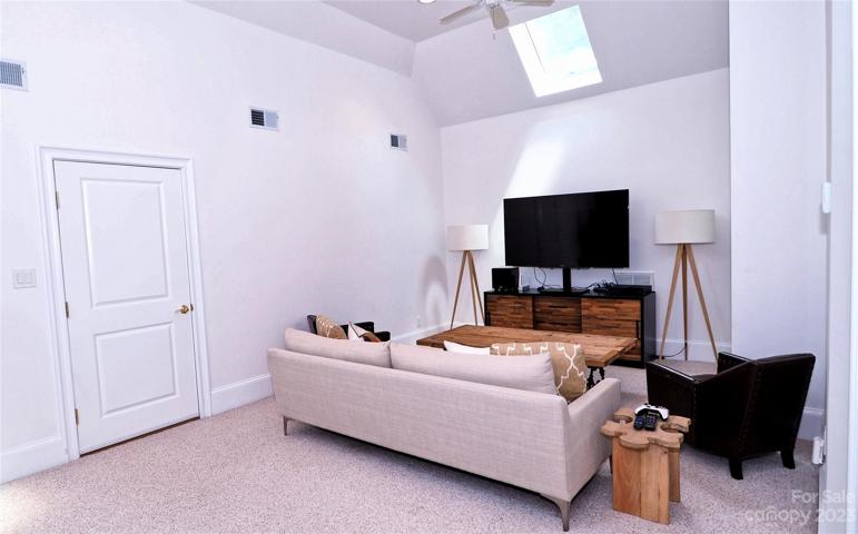MEDIA ROOM: two skylights, walk in attic . Not pictured is the Kitchenette with 12"x24" tile, floating shelf, beverage refrigerator and more.