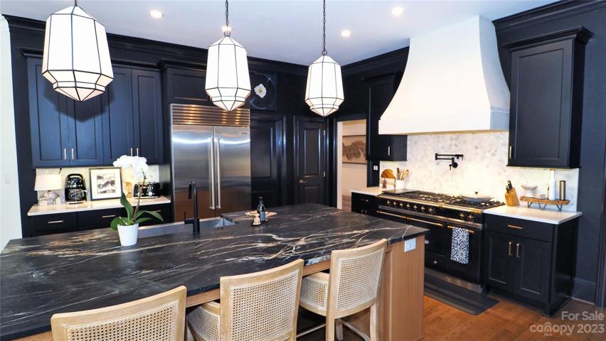 Custom finished 54" HOOD with white textured finish. Moen® pot filler and faucet, Kholer® sink, Bosh® dishwasher.