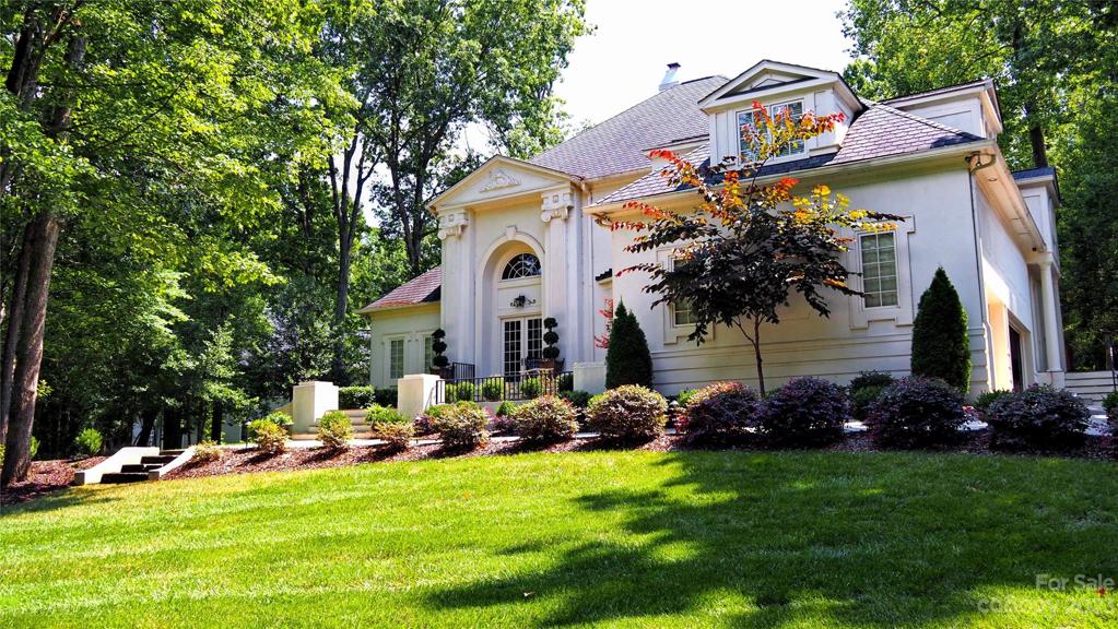House majestically situated on a hill with a circular driveway. THREE CAR GARAGE: with plenty of built-in cabinetry. A MUST See House!