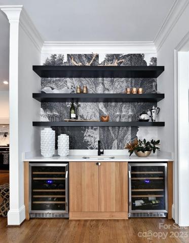 WET BAR features: floating shelves, two beverage refrigerators, abstract wall paper, quartz countertop and undermount sink.