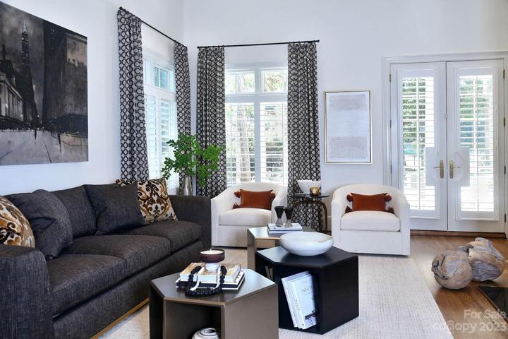 Spacious living room with ample space, light and dramatic fireplace.