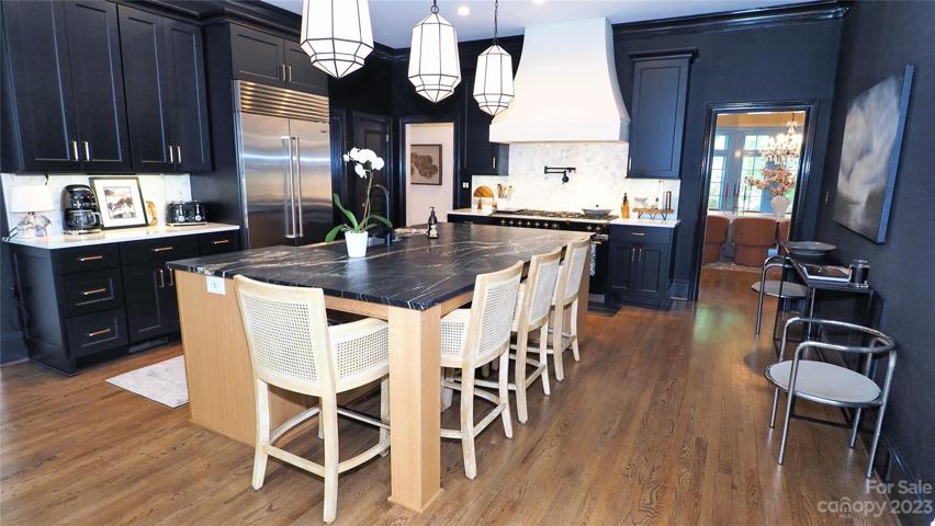 NEW Award Winning  2022 KITCHEN: LaCanche® French Range, Sub Zero® refrigerator, black grass cloth wallpaper.