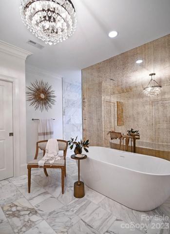SOAKING TUB with coordinating champagne finish Kohler® hardware.