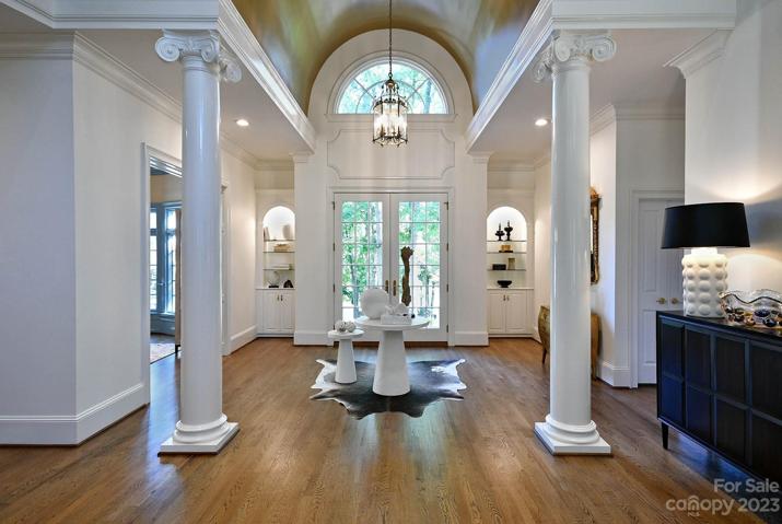 FOYER: gold barrel vaulted ceiling and lighted built in's with glass shelves.