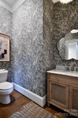 Grass cloth wallpaper, custom hardware and mirror.