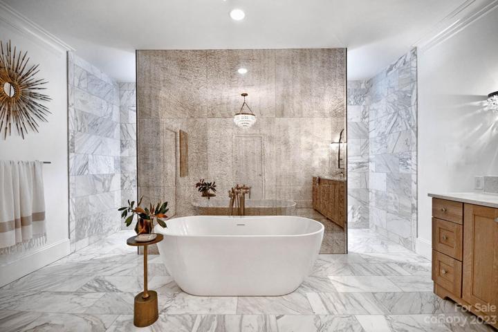 ONWERS SUITE double award winning BATHROM: custom mirror paneled wall.  Crystal chandelier and coordinating SCONCES.