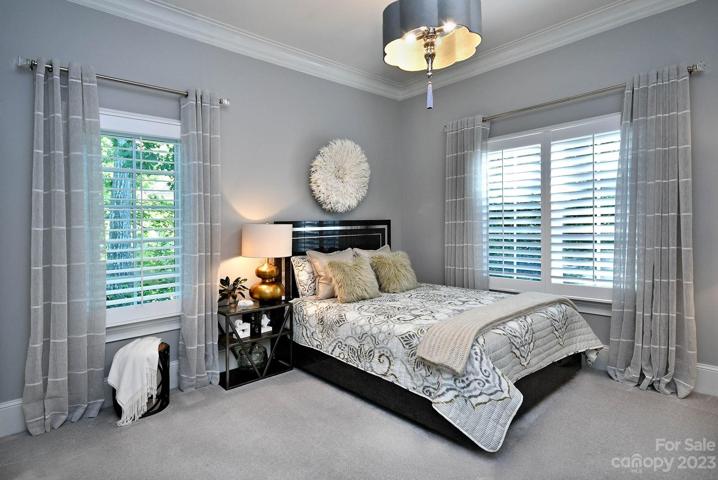 GUEST BEDROOM on Main: new carpet, wallpapered ceiling & custom chandelier. Ten foot ceilings on main floor.