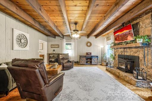 Living Room with stone fireplace and wood burning stove to enjoy in the colder months