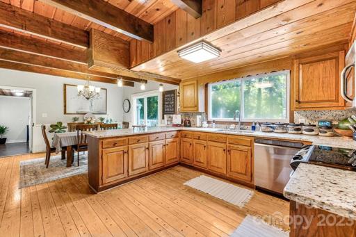 Kitchen with granite countertops and stainless appliances.  Pretty view of the deck, backyard and barn!