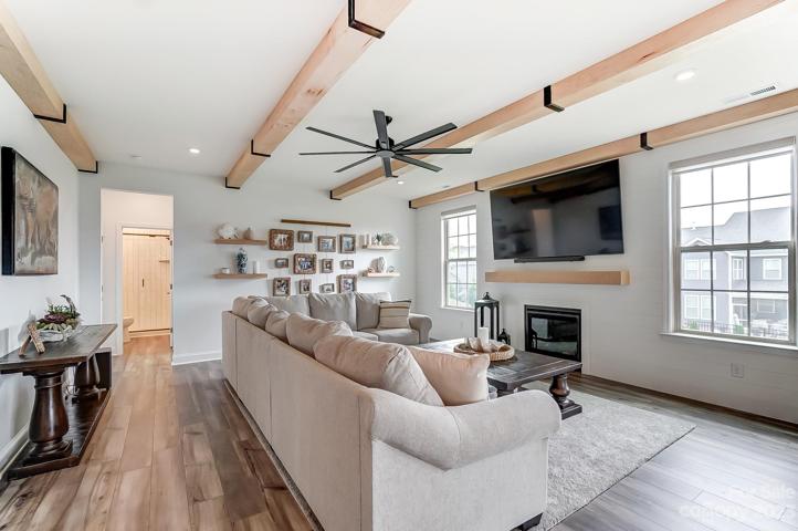 Large family room with upgraded white oak beams and mantel