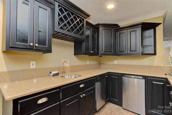 Can be used as a wet bar, small secondary kitchen as it features a small sink, little refrigerator and ice maker (sold as is, owners never used) and plenty of cabinets/drawers.