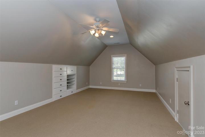 Bedroom 5 upstairs with some builtins plus has a closet, ceiling fan w/light, 2 inch blinds on windows and an attic access door.