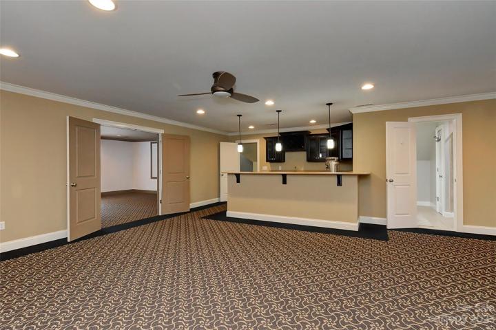 Great room or extra bonus room with upgraded carpet, ceiling fan w/light, recessed lighting w/an awesome breakfast/wet bar with plenty of space for bar chairs and pendant lighting.