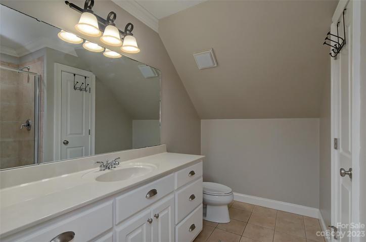 Full bath upstairs with tiled wall shower, linen closet and plenty of shared vanity space.