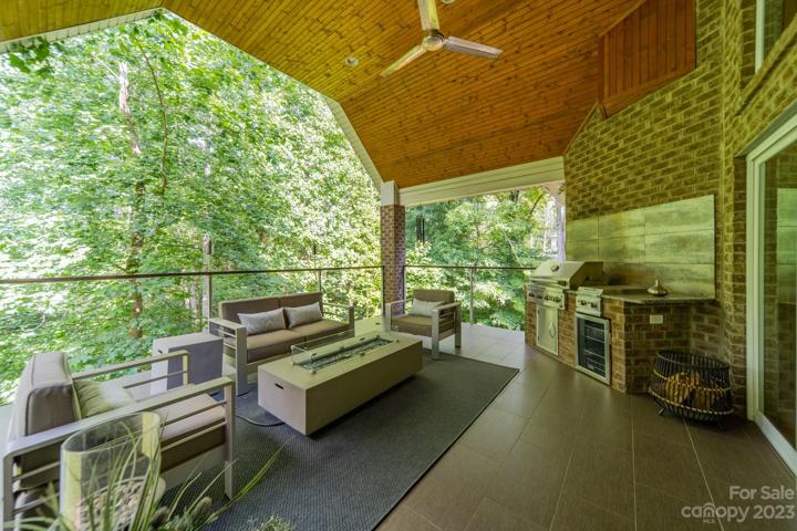 Covered patio features gas grill and beverage center.